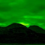 Photographing Greenland's Climate Change and Primordial Landscapes at Night: Northern Lights Above Mountains