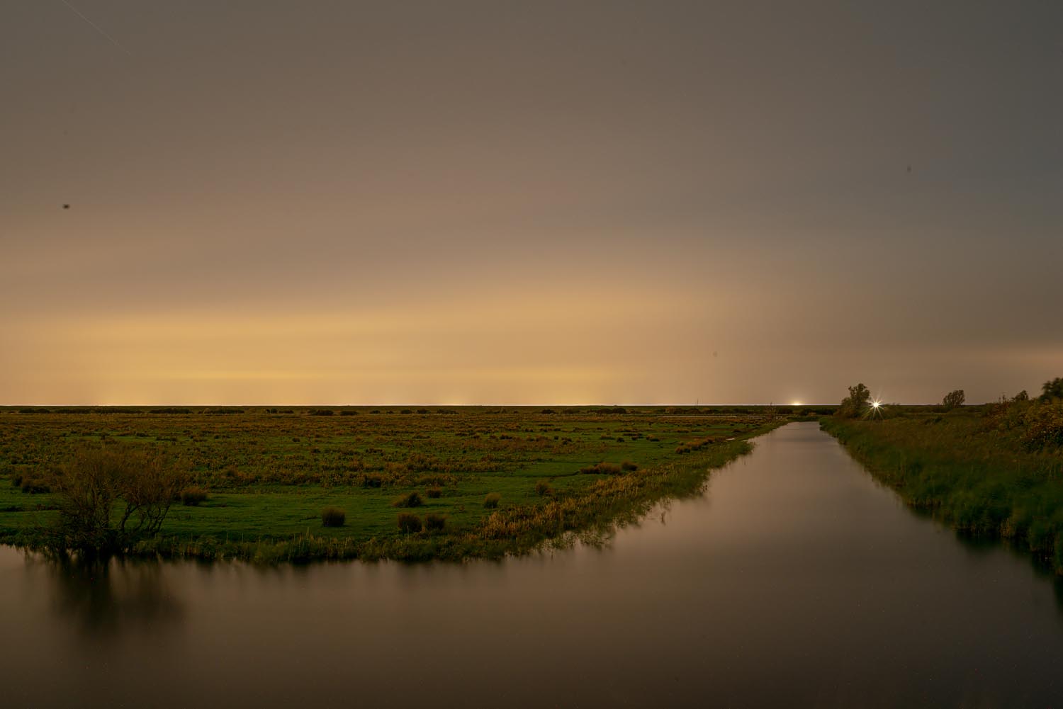 Sites at Risk of Climate Change: Night Landscape Photographs in The Netherlands, Steve Giovinco, Canal, Nieuw Land National Park, with Light in Distance, Flevoland