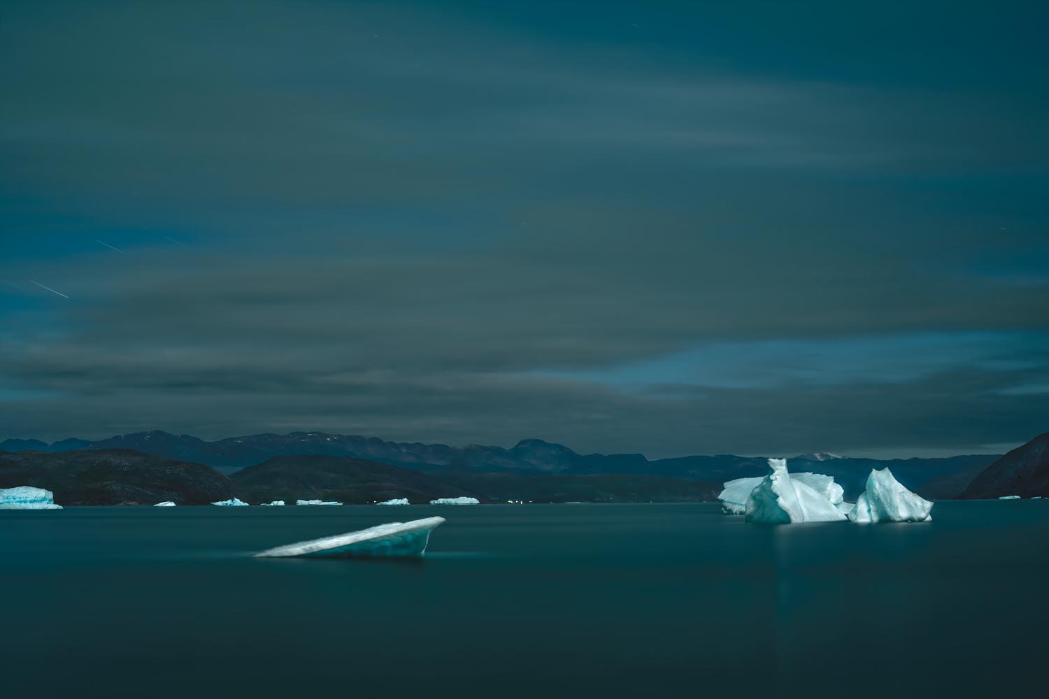 Shadow and Light: New Night Landscape Photographs of Greenland By Steve Giovinco. Icebergs, Moving in the Night in Fjord