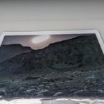 Arctic Edge, Photography Exhibition at Scandinavia House NYC, Night Landscape Photos of Greenland, By Steve Giovinco Print on Table, Moon Rising Over Rocky Cliff